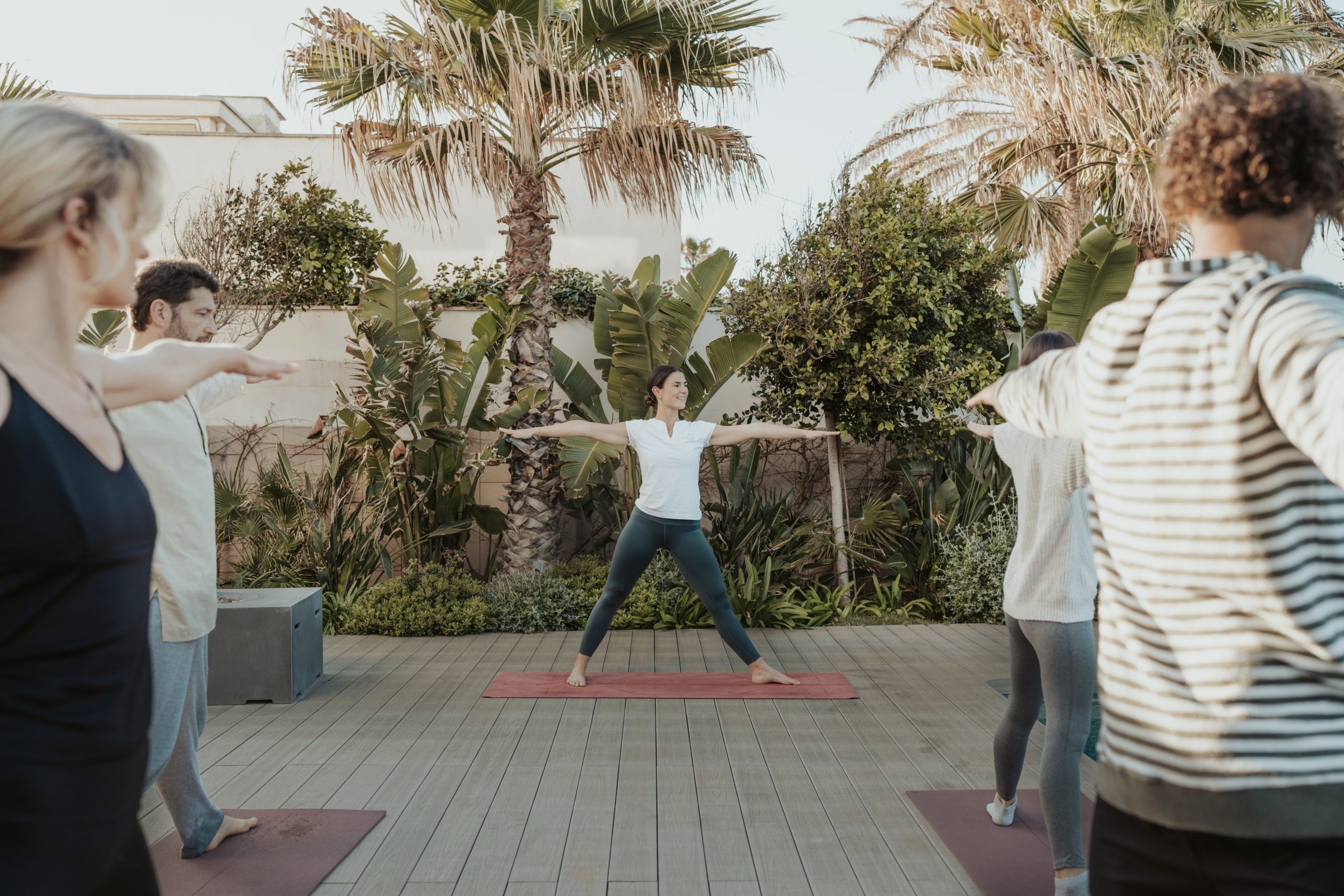 People practising standing movements on a terrace
